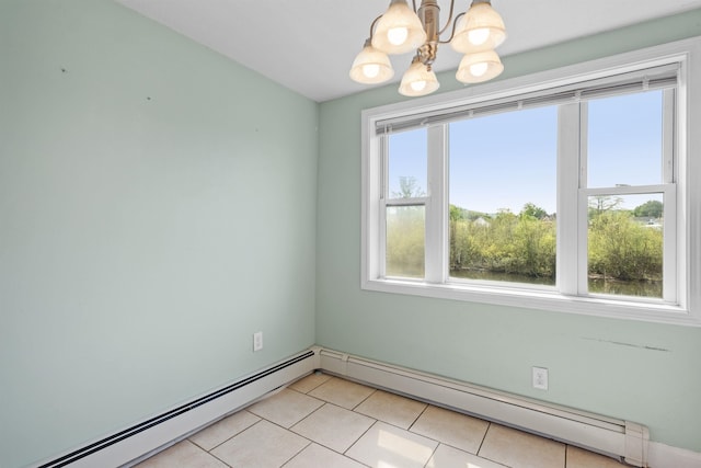 unfurnished room featuring a baseboard radiator, an inviting chandelier, and a healthy amount of sunlight