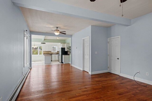 interior space with hardwood / wood-style floors, a baseboard radiator, and ceiling fan