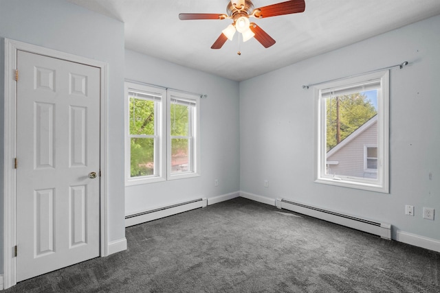 carpeted empty room with ceiling fan and a baseboard radiator