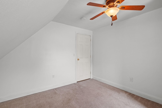 additional living space with light colored carpet, ceiling fan, and lofted ceiling