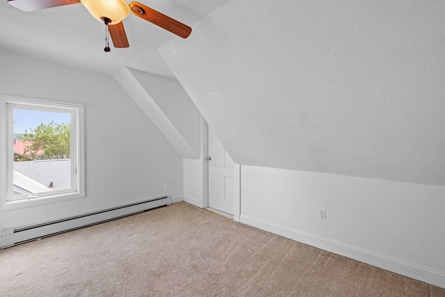 bonus room featuring light carpet, ceiling fan, vaulted ceiling, and a baseboard heating unit