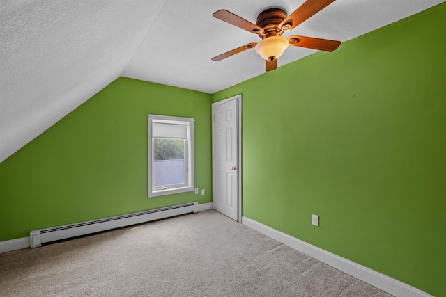 additional living space with ceiling fan, a baseboard radiator, a textured ceiling, lofted ceiling, and light carpet