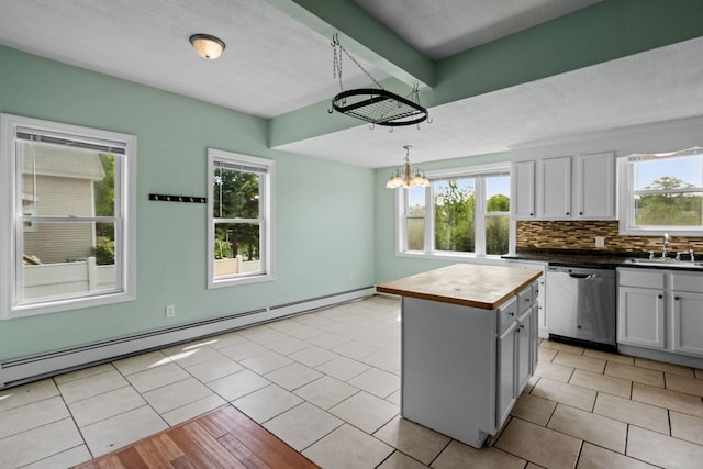 kitchen featuring dishwasher, a center island, a wealth of natural light, and beamed ceiling