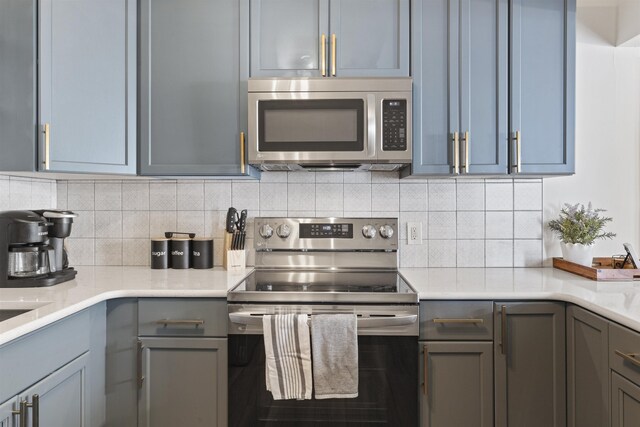 kitchen with stainless steel appliances and tasteful backsplash