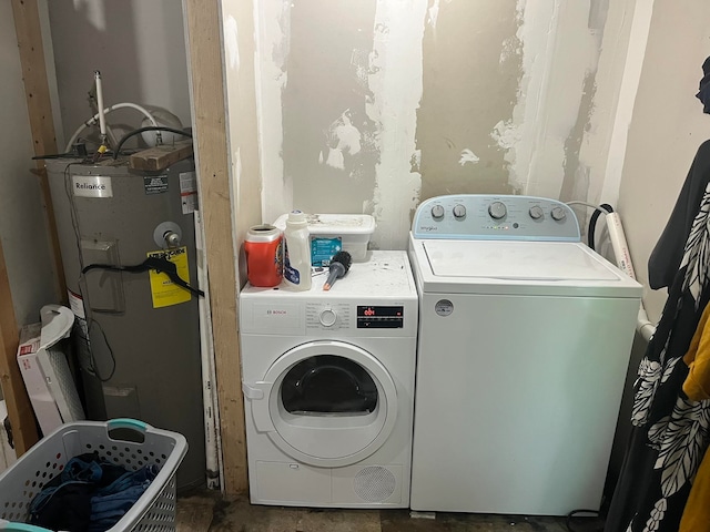 washroom with washing machine and dryer and water heater