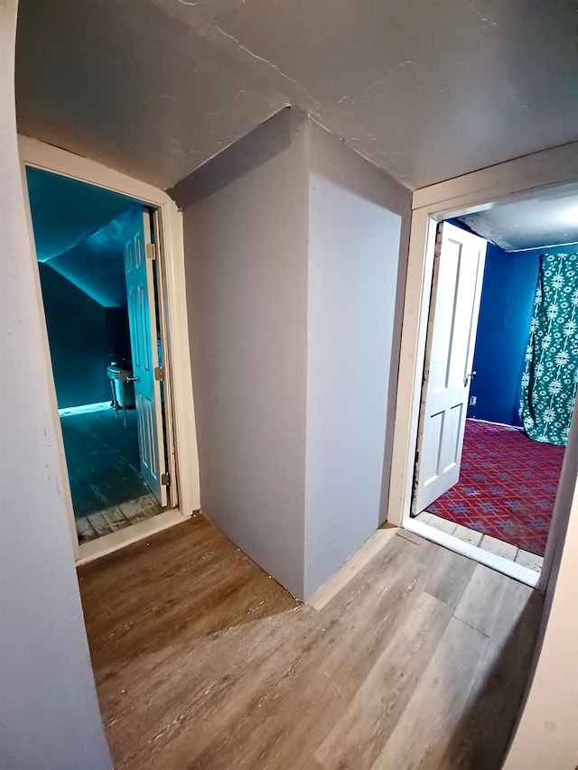 hallway with hardwood / wood-style flooring