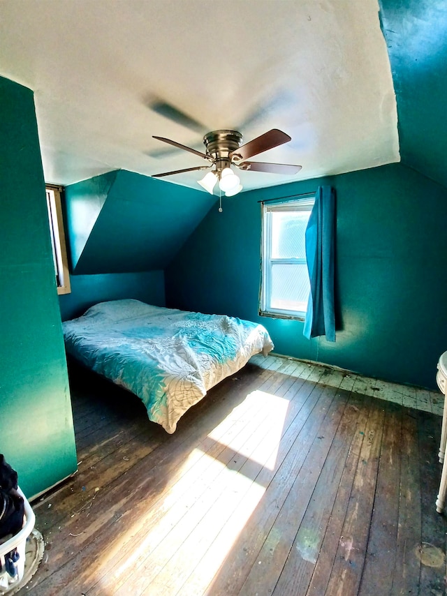 bedroom with hardwood / wood-style floors, vaulted ceiling, and ceiling fan