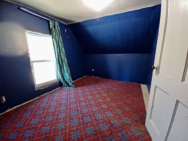 additional living space featuring lofted ceiling