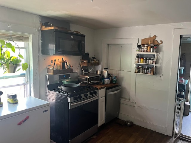 kitchen with stainless steel appliances and dark wood-type flooring