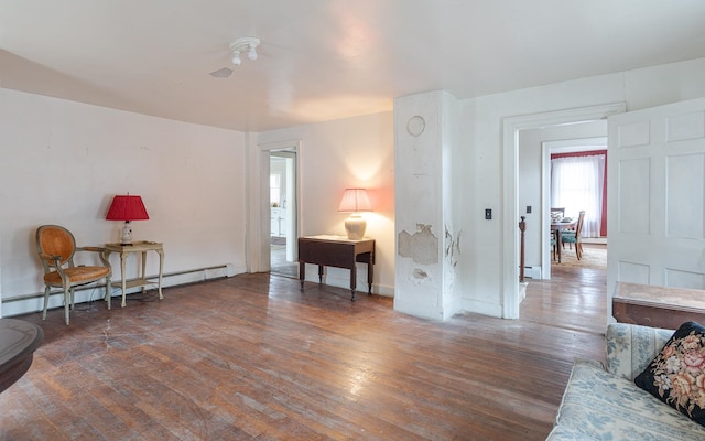 sitting room with dark hardwood / wood-style flooring and a baseboard radiator