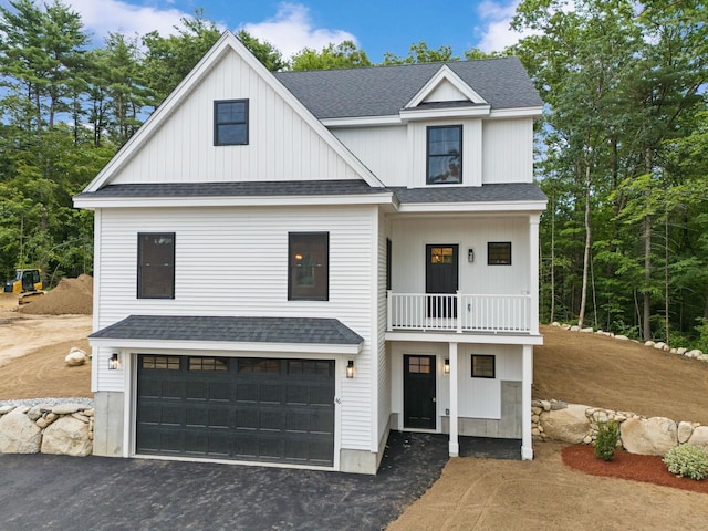 modern farmhouse with a balcony and a garage