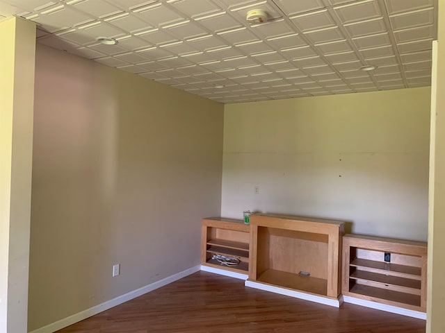 interior space with baseboards and dark wood-style flooring