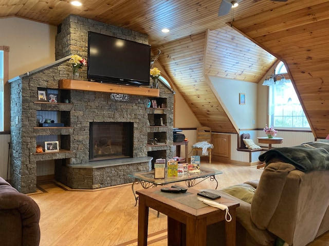 living area with lofted ceiling, wood ceiling, light wood-style flooring, and a fireplace