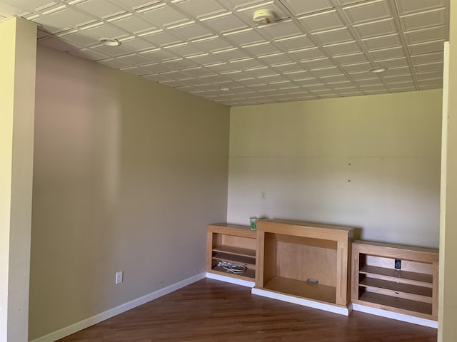 interior space with baseboards and dark wood finished floors