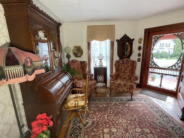 sitting room featuring plenty of natural light and crown molding