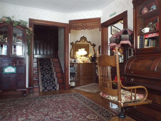 interior space featuring stairs, wood finished floors, crown molding, and wallpapered walls