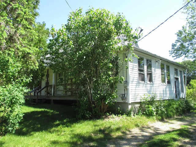 view of home's exterior with a lawn