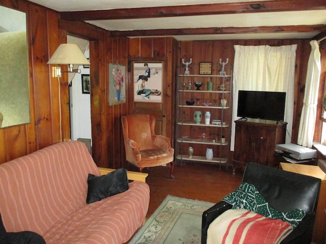 living room with beam ceiling and wooden walls