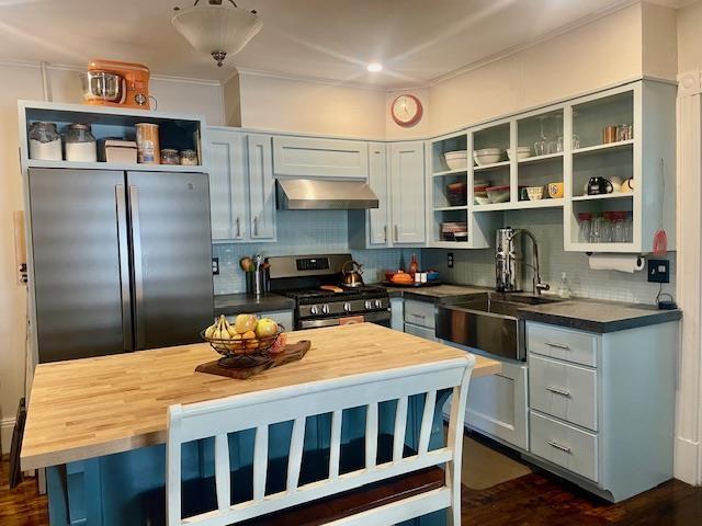 kitchen with stainless steel appliances, dark hardwood / wood-style floors, sink, backsplash, and butcher block counters