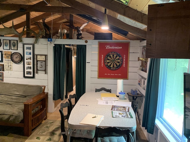 dining room featuring lofted ceiling with beams