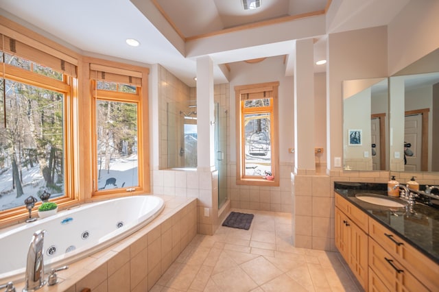 bathroom with tile patterned flooring, vanity, and plus walk in shower