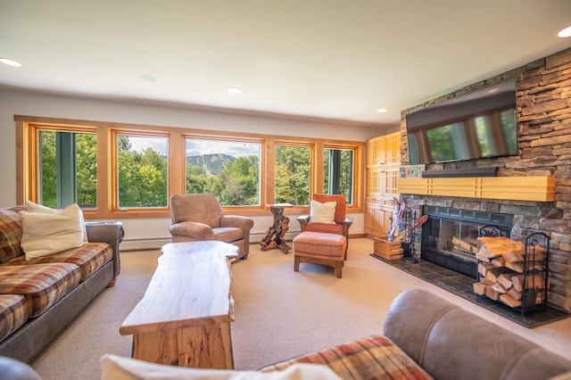 carpeted living room with a wealth of natural light, a fireplace, and a baseboard radiator