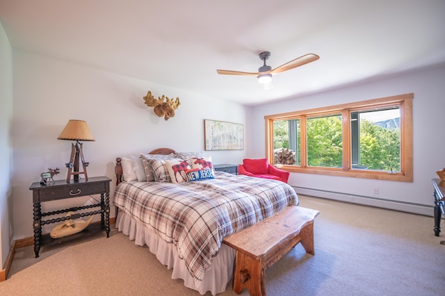 carpeted bedroom with baseboard heating and ceiling fan