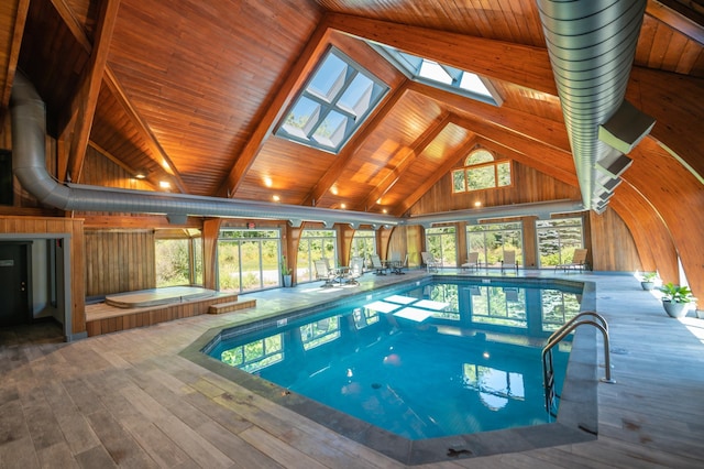 view of pool with an indoor hot tub and a skylight