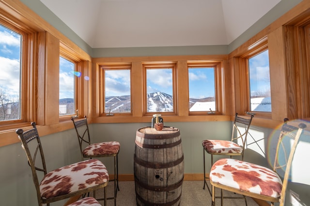 living area featuring a mountain view and lofted ceiling