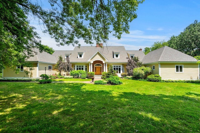 cape cod home with a chimney and a front lawn