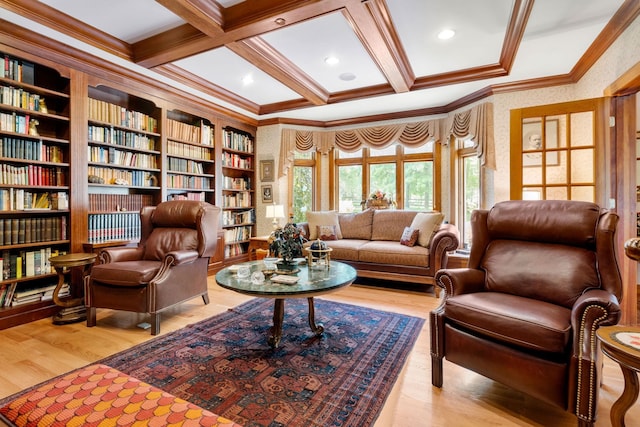 living area featuring beamed ceiling, coffered ceiling, wood finished floors, and ornamental molding