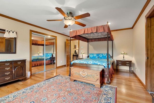 bedroom featuring light wood finished floors, wallpapered walls, baseboards, and ornamental molding