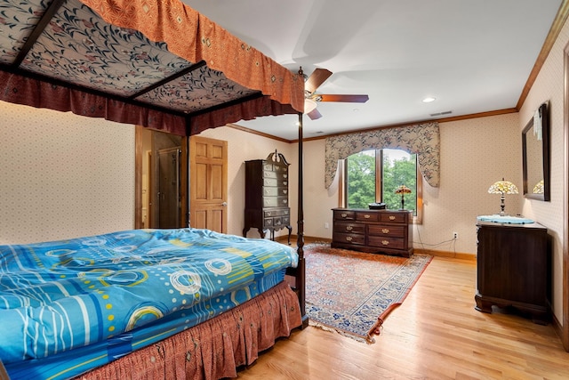 bedroom with wallpapered walls, crown molding, wood finished floors, and visible vents