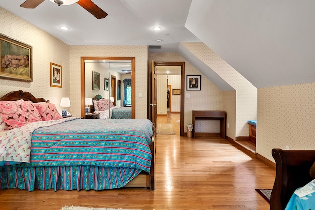 bedroom featuring wallpapered walls and wood finished floors