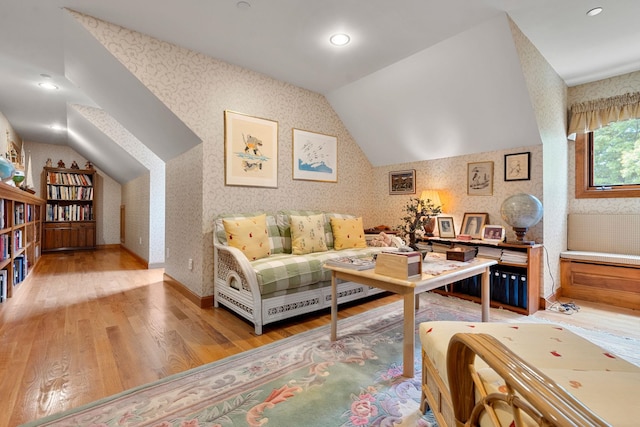 living area featuring lofted ceiling, wallpapered walls, recessed lighting, light wood finished floors, and baseboards