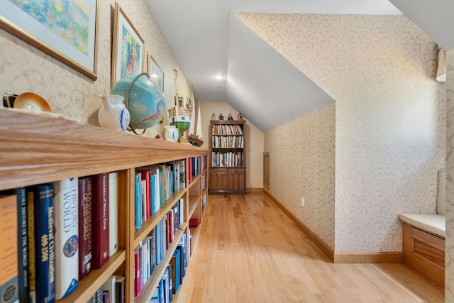 hall with wallpapered walls, baseboards, vaulted ceiling, recessed lighting, and light wood-style floors