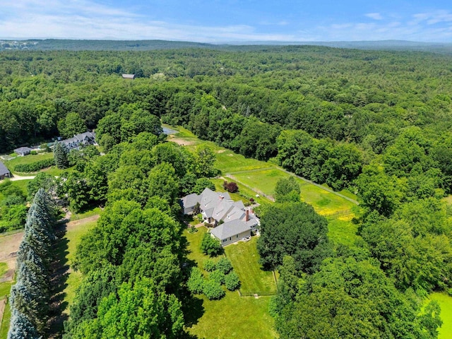 drone / aerial view featuring a wooded view