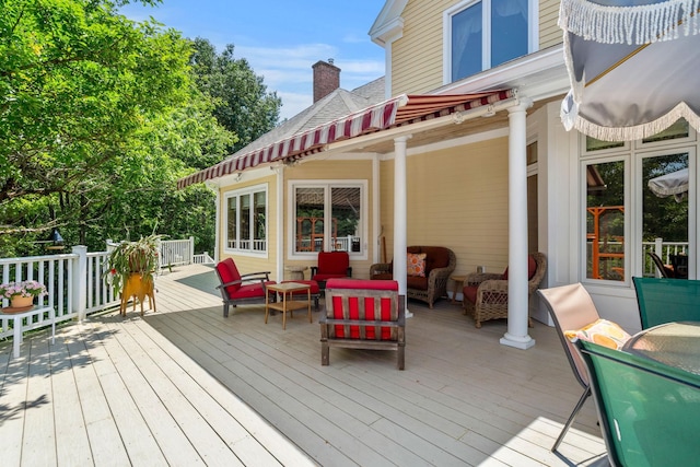 wooden terrace featuring an outdoor living space