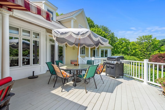 wooden deck featuring outdoor dining area and area for grilling