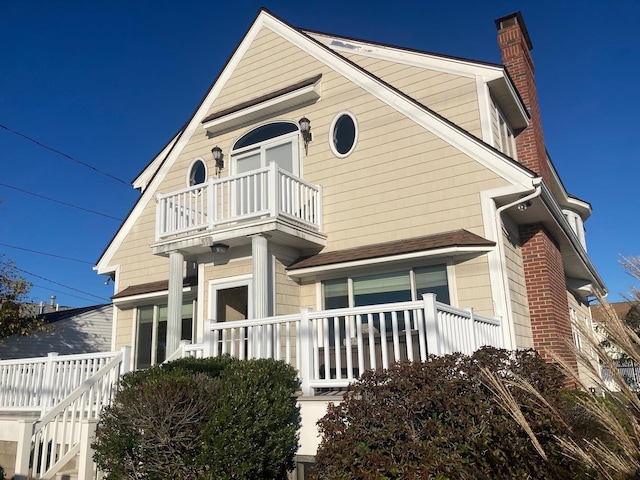 view of side of home featuring a balcony