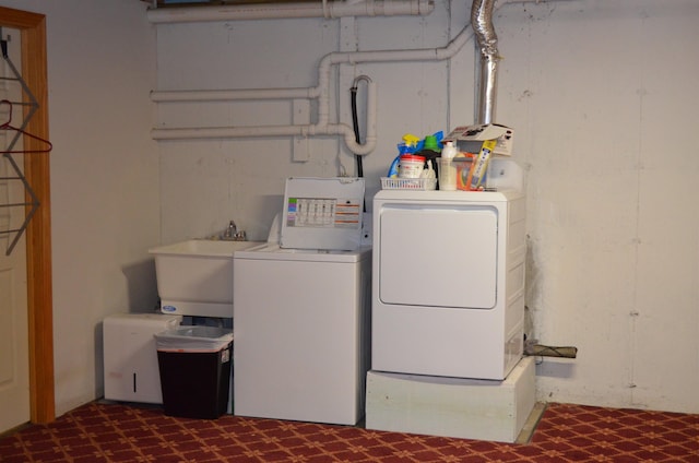 washroom with independent washer and dryer and sink