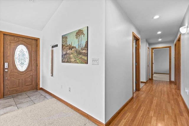 foyer featuring lofted ceiling and light hardwood / wood-style flooring