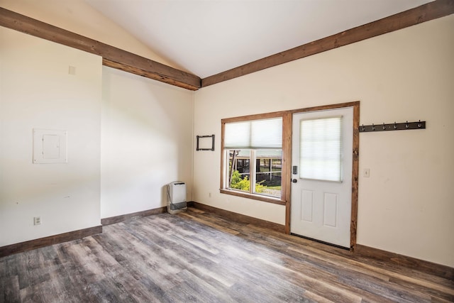 spare room with vaulted ceiling, heating unit, and dark hardwood / wood-style floors