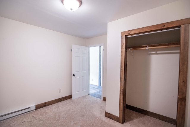 unfurnished bedroom with a baseboard radiator, a closet, and light colored carpet