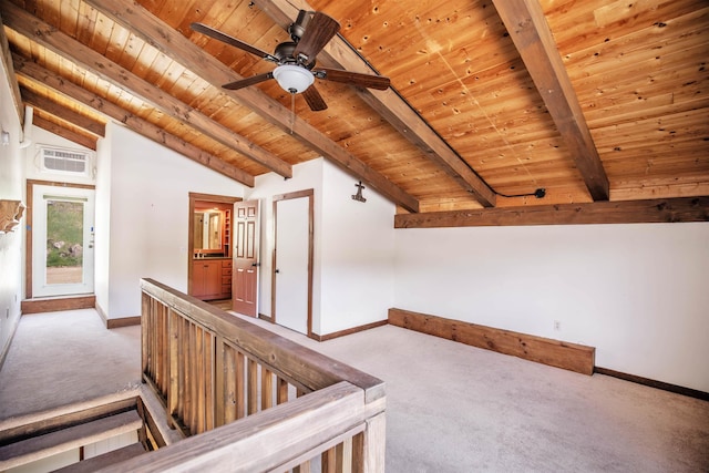 hall featuring beam ceiling, light colored carpet, and wood ceiling