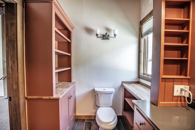 bathroom with hardwood / wood-style floors, a healthy amount of sunlight, and toilet