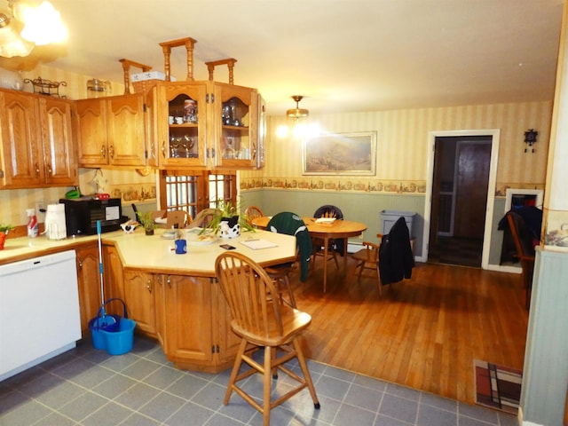 kitchen featuring light tile patterned floors and white dishwasher