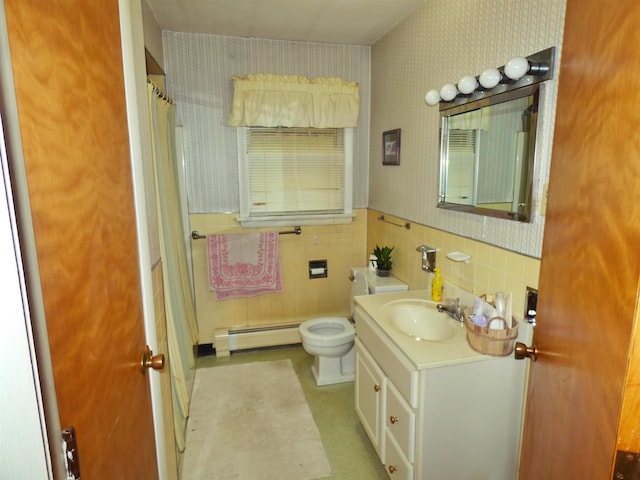 bathroom featuring baseboard heating, vanity, tile walls, and toilet