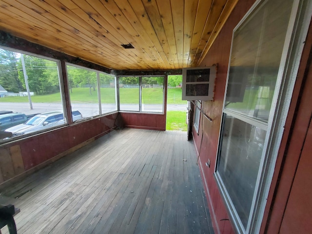 unfurnished sunroom with wood ceiling