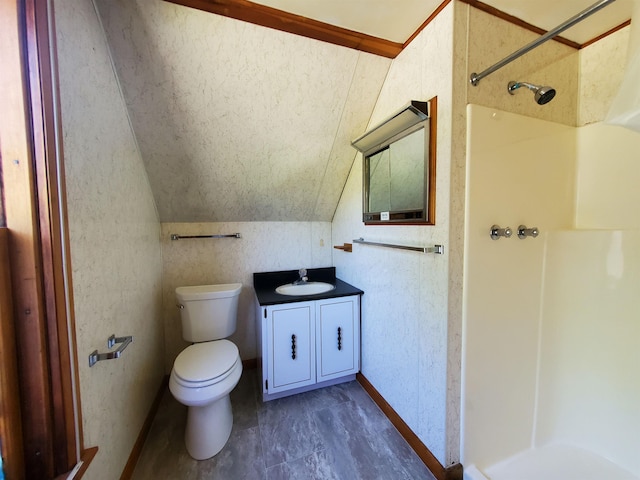 bathroom featuring vanity, toilet, lofted ceiling, and a shower